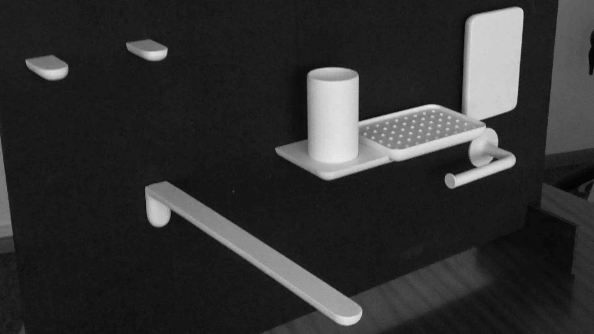 Black-and-white view of a modular wall fixture displaying white prototypes including towel rails, tumblers, and tray holders by Bodenschatz.