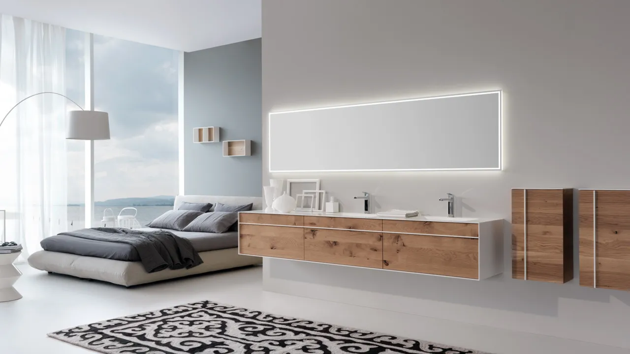 A large, light-filled room. In the foreground, a floating vanity made of wood and white Corian. In the background, a modern bed and a sweeping view.